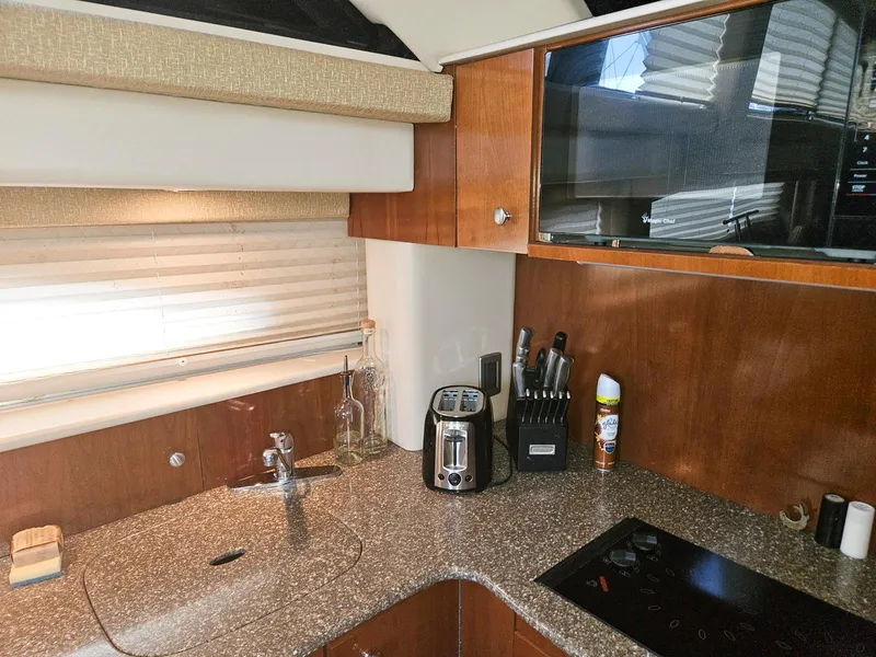 Slide: The Image of Luxurious kitchen interior of 2005 Meridian 368 Motoryacht with modern appliances and wood cabinetry. - 21