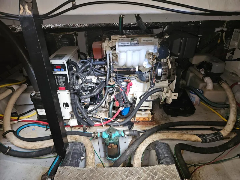 Slide: The Image of Engine room of a 2005 Meridian 368 Motoryacht, showcasing mechanical components and wiring. - 26