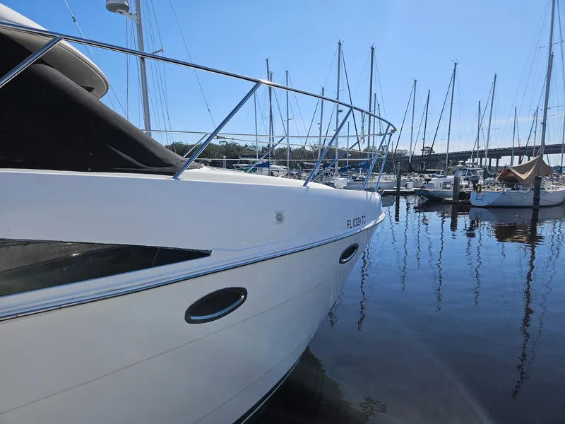 Slide: The Image of 2005 Meridian 368 Motoryacht docked in a marina, surrounded by sailboats. - 3