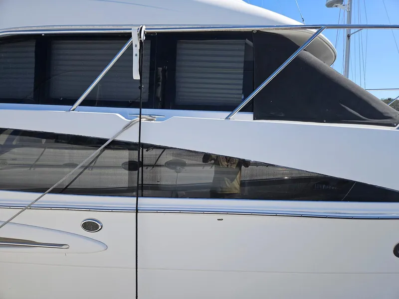 Slide: The Image of 2005 Meridian 368 Motoryacht side view with sleek design and modern windows. - 4