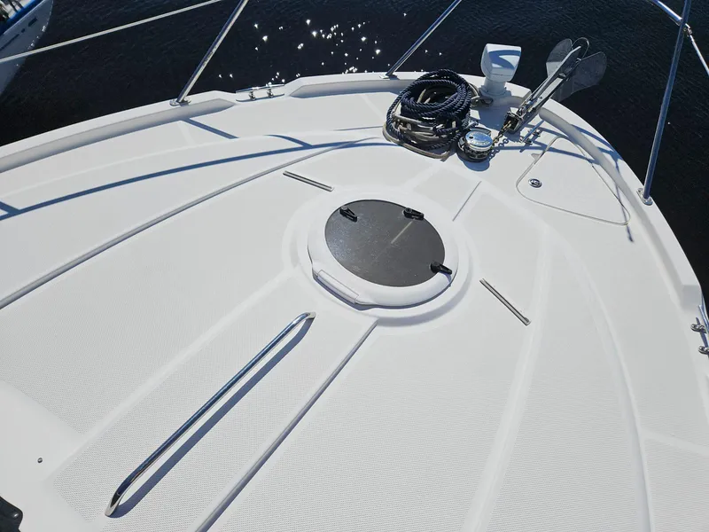 Slide: The Image of 2005 Meridian 368 Motoryacht deck with anchor and hatch, under clear blue sky. - 6