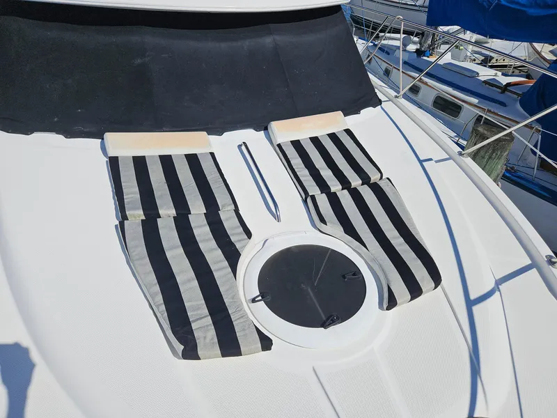 Slide: The Image of 2005 Meridian 368 Motoryacht deck with striped sun loungers and hatch. - 7