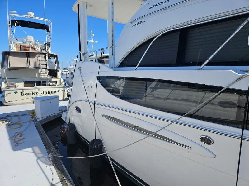 Slide: The Image of 2005 Meridian 368 Motoryacht docked at marina, side view with clear blue sky. - 8