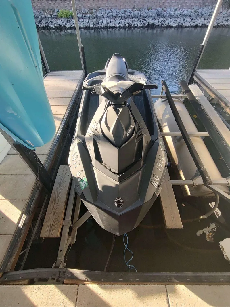 Slide: The Image of 2015 Sea-Doo Spark 2up jet ski docked by a calm waterway. - 3