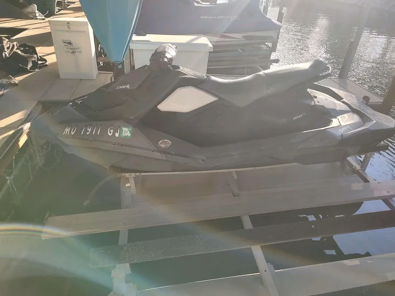 Slide: The Image of 2015 Sea-Doo Spark 2up jet ski docked by the water. - 4