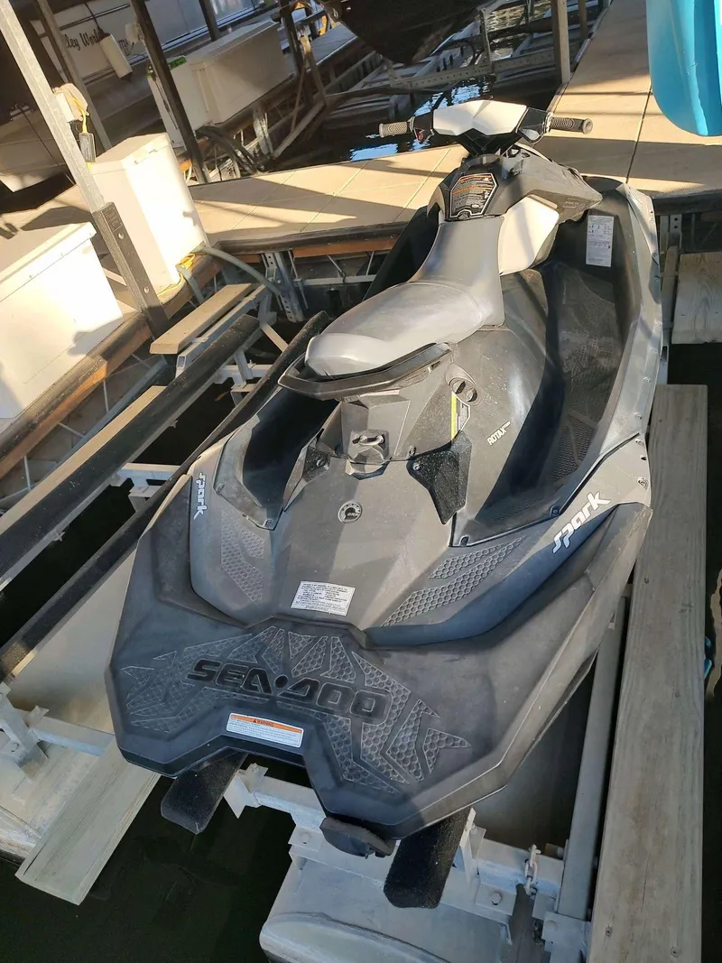 Slide: The Image of 2015 Sea-Doo Spark 2up jet ski docked, black and white design, top view. - 5