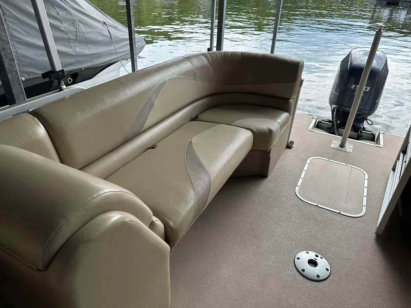 Slide: The Image of 2013 G3 SunCatcher V322 RC pontoon boat interior with tan seating and outboard motor. - 12