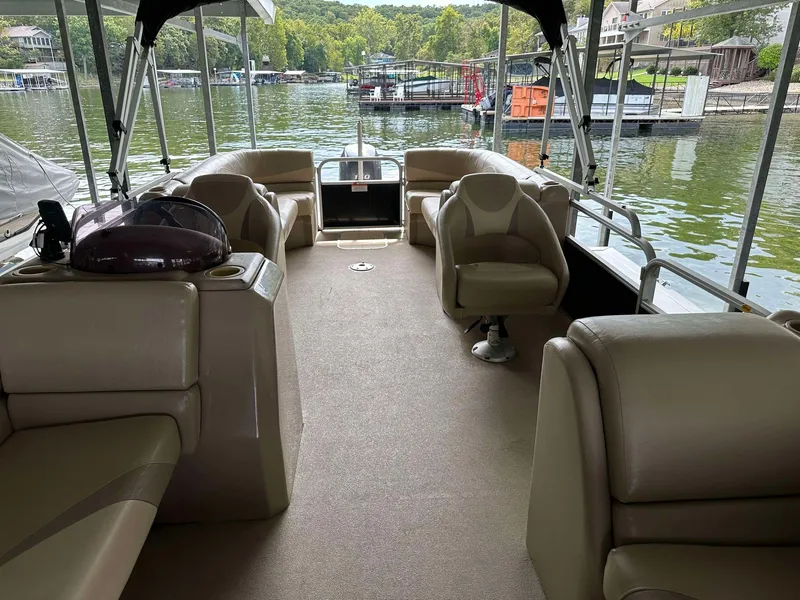 Slide: The Image of 2013 G3 SunCatcher V322 RC pontoon boat interior with beige seating on a lake. - 13