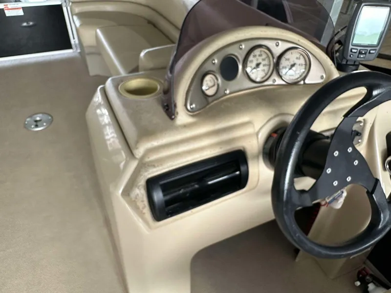 Slide: The Image of 2013 G3 SunCatcher V322 RC boat dashboard with steering wheel and gauges. - 16