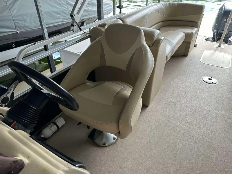 Slide: The Image of 2013 G3 SunCatcher V322 RC boat interior with beige seating and steering wheel. - 18