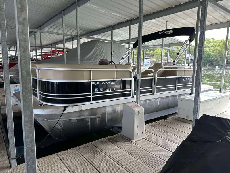 Slide: The Image of 2013 G3 SunCatcher V322 RC pontoon boat docked under a covered marina. - 19