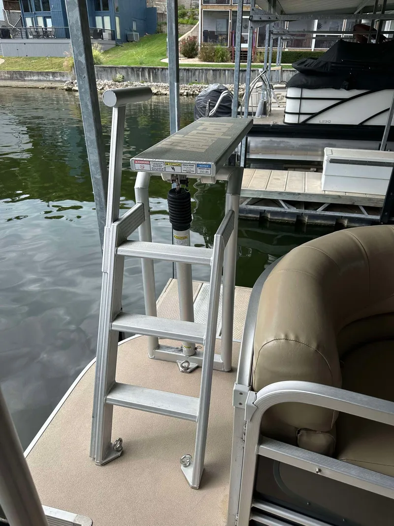 Slide: The Image of Aluminum ladder on 2013 G3 SunCatcher V322 RC pontoon boat docked by the water. - 2