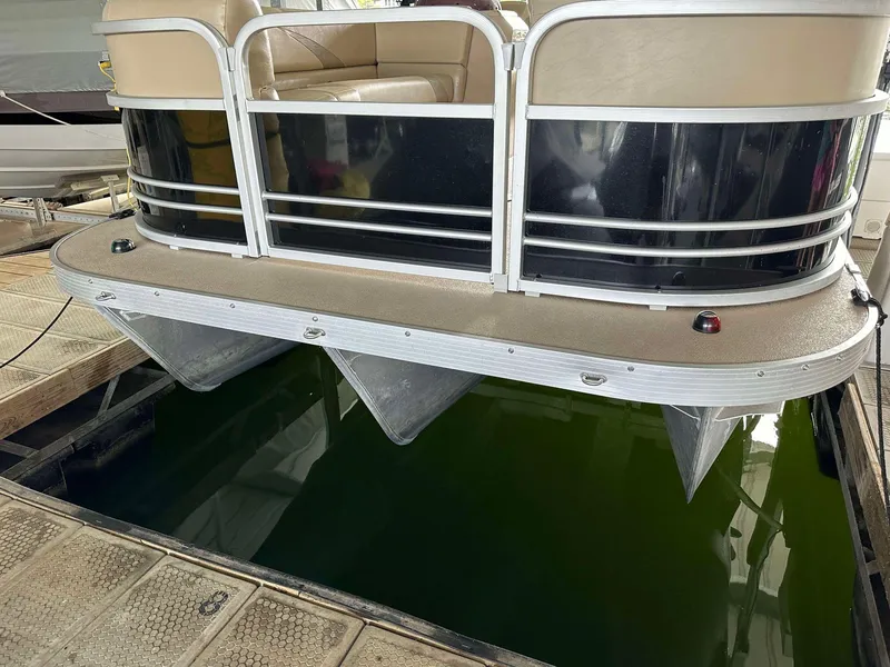 Slide: The Image of 2013 G3 SunCatcher V322 RC pontoon boat docked, showcasing seating and railing. - 21
