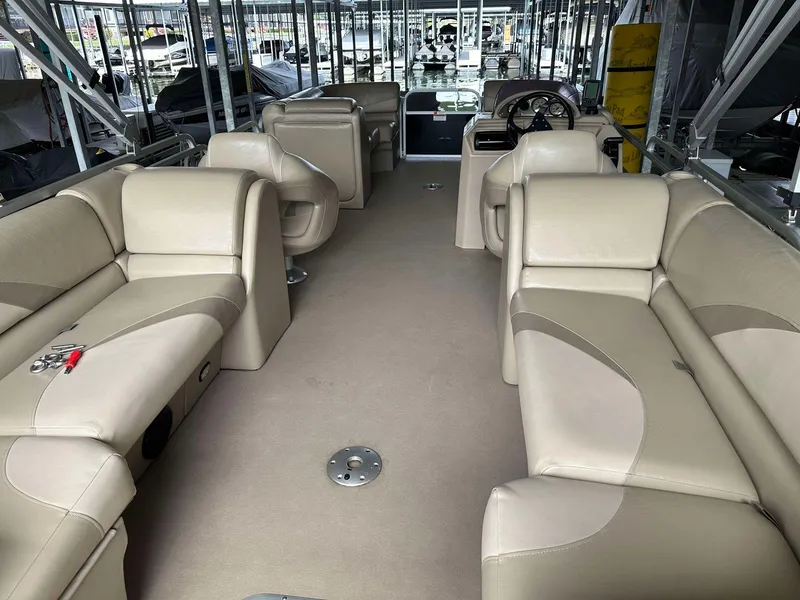 Slide: The Image of 2013 G3 SunCatcher V322 RC pontoon boat interior with beige seating and steering console. - 22