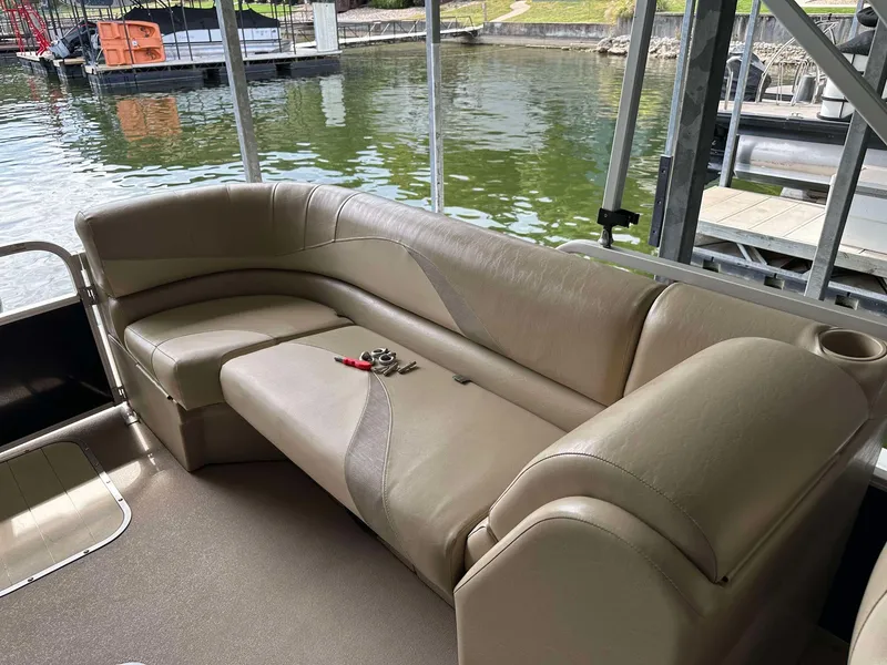 Slide: The Image of 2013 G3 SunCatcher V322 RC pontoon boat interior with beige seating by the water. - 24