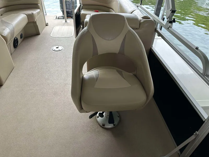 Slide: The Image of 2013 G3 SunCatcher V322 RC boat interior with beige seating and carpet. - 26