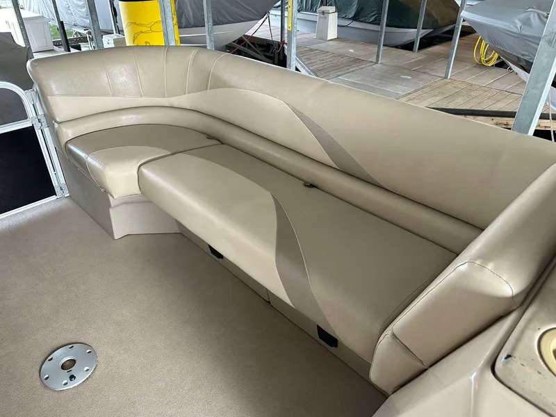 Slide: The Image of 2013 G3 SunCatcher V322 RC boat interior with beige seating and carpeted floor. - 3