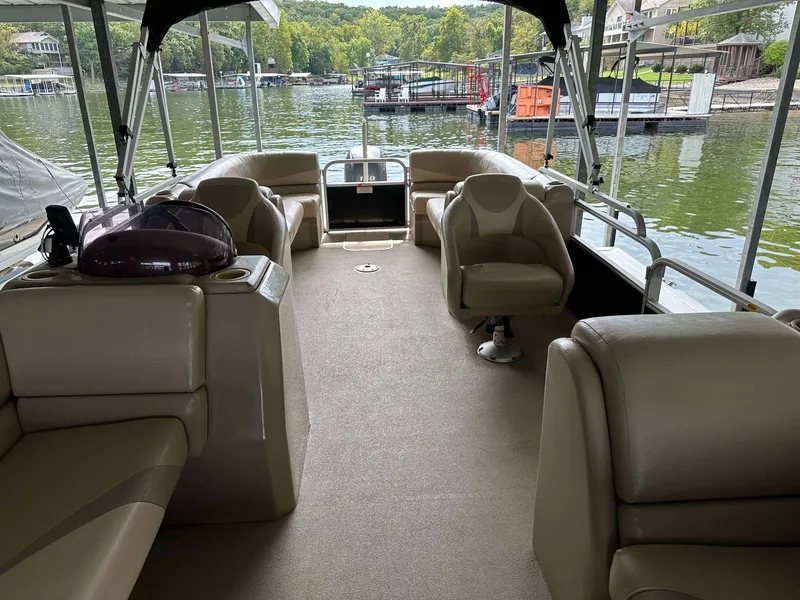 Slide: The Image of 2013 G3 SunCatcher V322 RC pontoon boat interior with beige seating, docked on a scenic lake. - 32