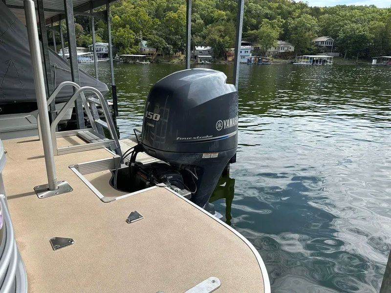 Slide: The Image of 2013 G3 SunCatcher V322 RC pontoon boat with Yamaha 150 engine on a serene lake. - 8
