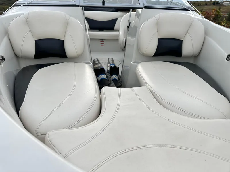 Slide: The Image of 2013 Tahoe Q4i boat interior with white cushioned seating and sleek design. - 11