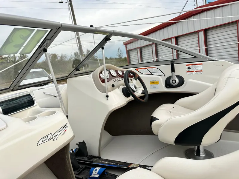 Slide: The Image of 2013 Tahoe Q4i boat interior with steering wheel and white seating. - 13