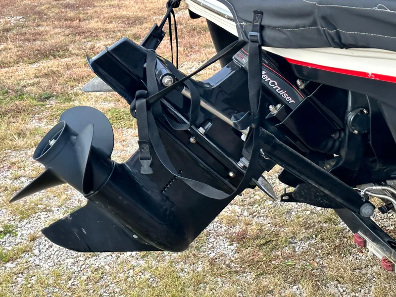 Slide: The Image of 2013 Tahoe Q4i boat engine and propeller on grassy surface. - 4
