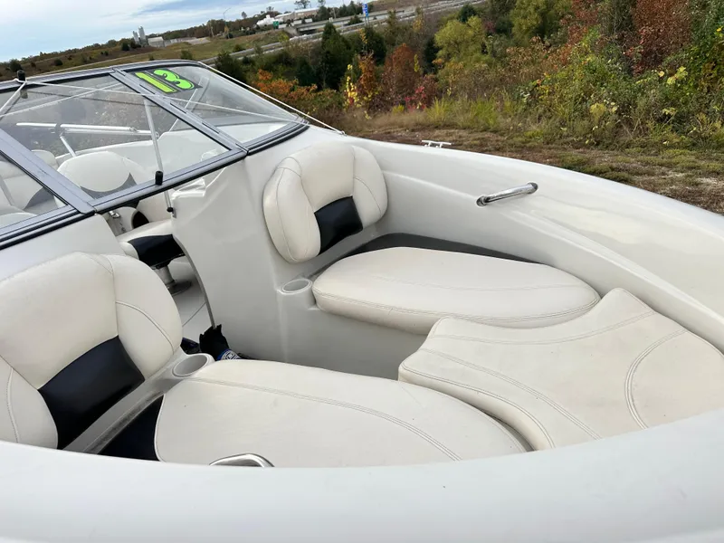 Slide: The Image of 2013 Tahoe Q4i boat interior with white leather seating and scenic background. - 5
