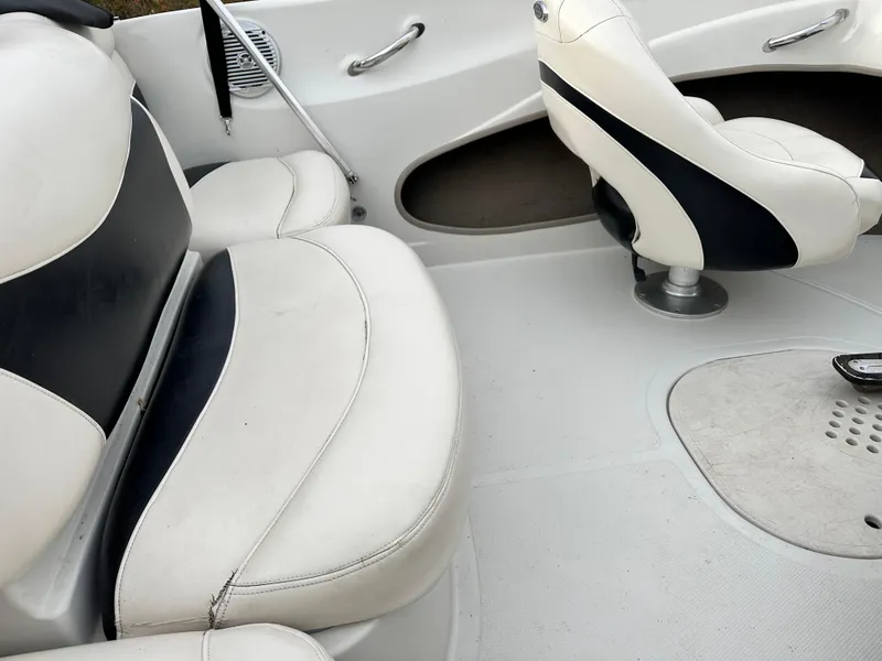Slide: The Image of Interior of a 2013 Tahoe Q4i boat with white and black seating. - 6