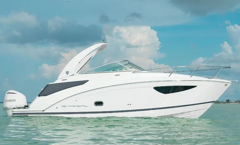 The Image of 2025 Regal 26 XO boat displayed in a marina, surrounded by other vessels. - 0