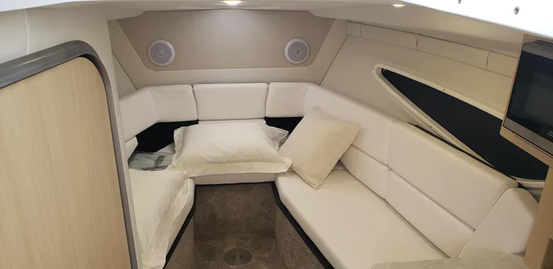 Slide: The Image of 2025 Regal 26 XO boat interior with luxurious white seating and cup holder. - 10
