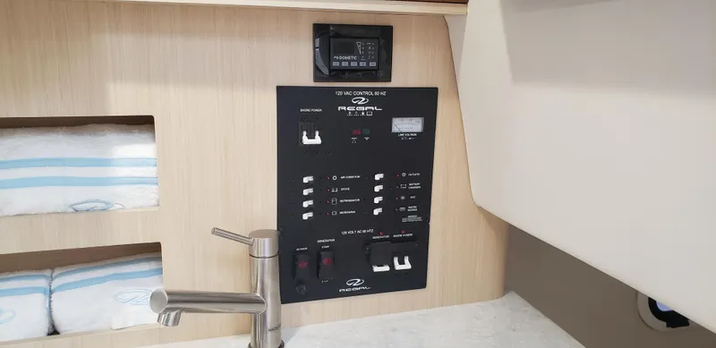 Slide: The Image of Open storage compartment on 2025 Regal 26 XO boat, showing interior contents. - 16