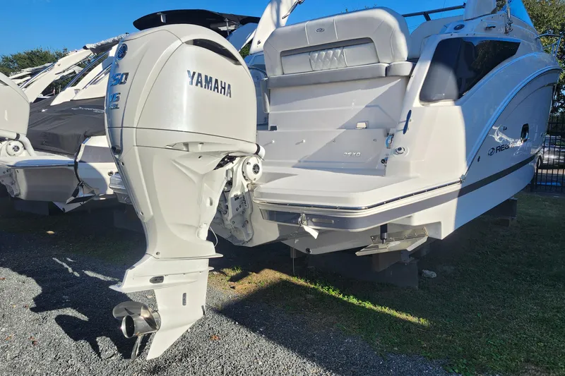 Slide: The Image of 2025 Regal 26 XO boat with Yamaha outboard motor, displayed outdoors. - 25