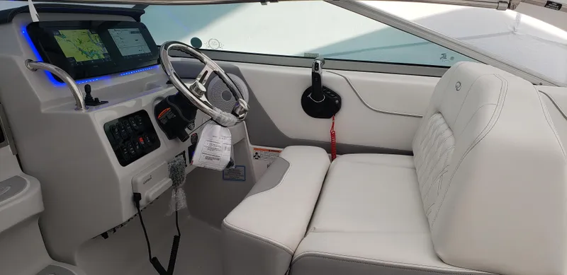 Slide: The Image of 2025 Regal 26 XO boat with open windshield, docked among other boats. - 4