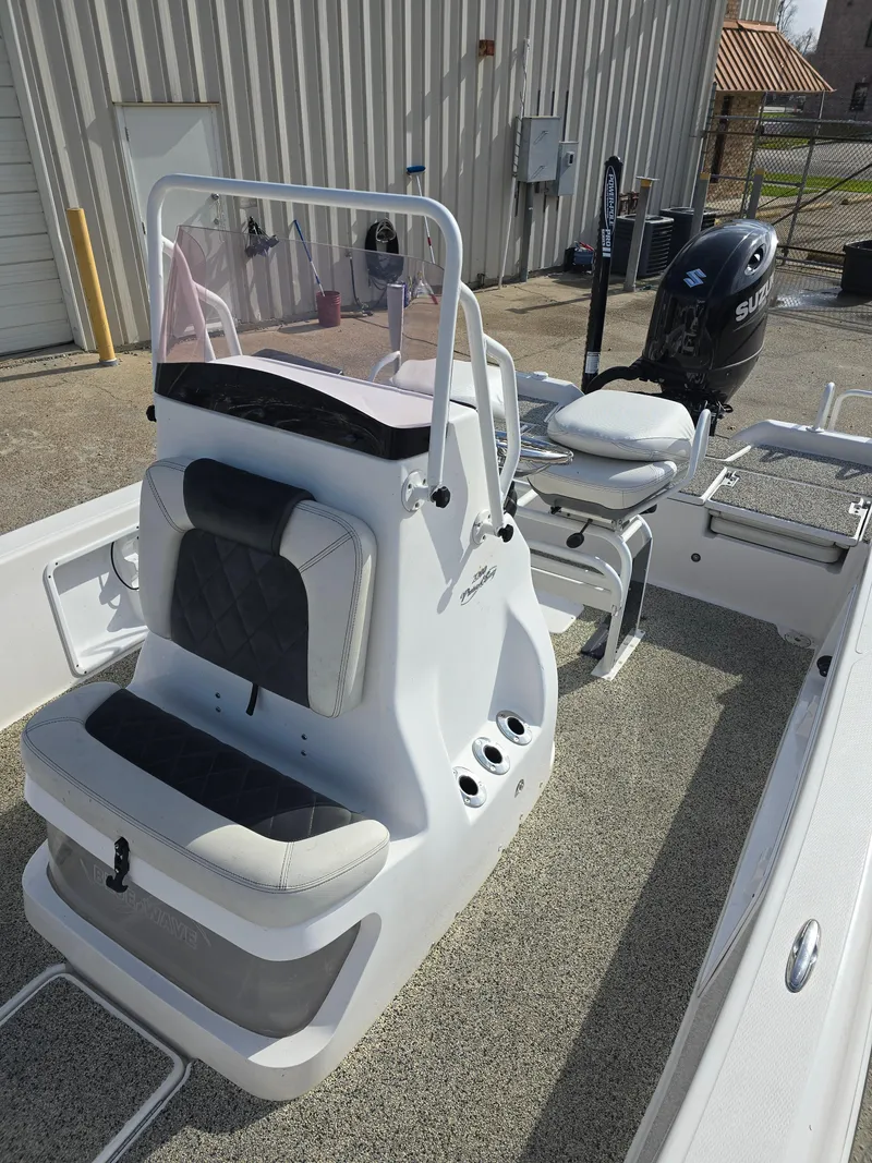 Slide: The Image of 2019 Blue Wave 2200 PureBay boat with seating and console, parked outdoors. - 11