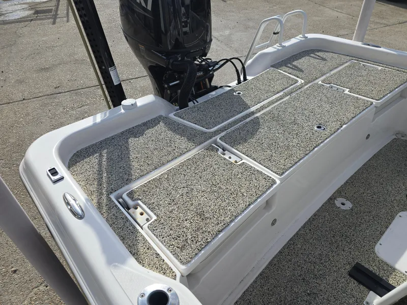 Slide: The Image of 2019 Blue Wave 2200 PureBay boat deck with storage compartments and motor. - 17