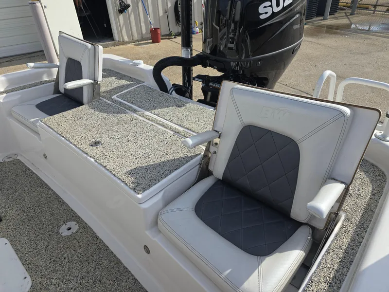 Slide: The Image of 2019 Blue Wave 2200 PureBay boat seats with Suzuki engine in background. - 18