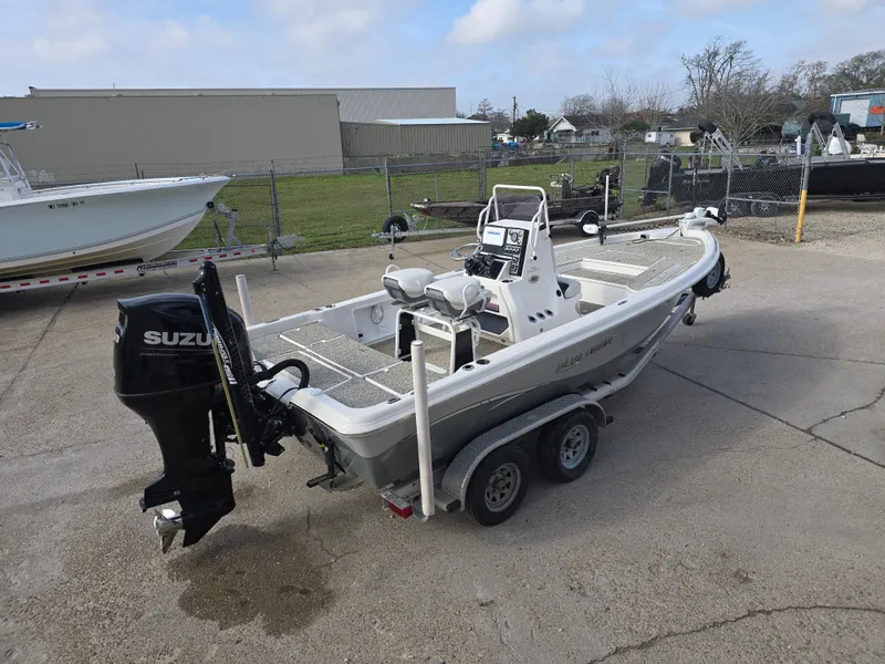 Slide: The Image of 2019 Blue Wave 2200 PureBay boat on trailer with Suzuki outboard motor. - 4