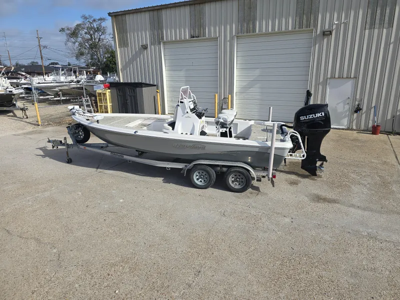 Slide: The Image of 2019 Blue Wave 2200 PureBay boat on trailer, parked outside a warehouse. - 7
