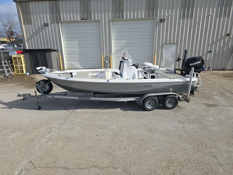 Slide: The Image of 2019 Blue Wave 2200 PureBay boat on trailer, parked outside industrial building. - 8