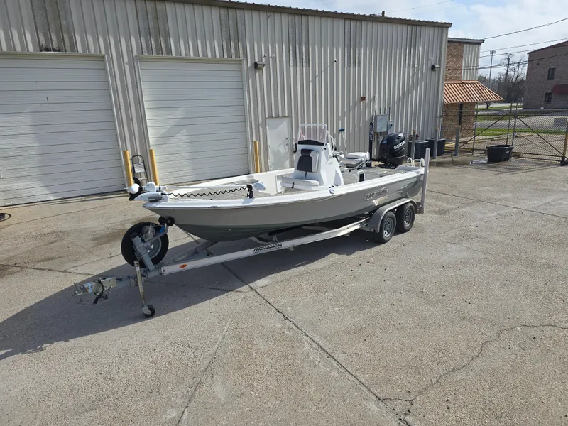 Slide: The Image of 2019 Blue Wave 2200 PureBay boat on trailer, parked outside industrial building. - 9
