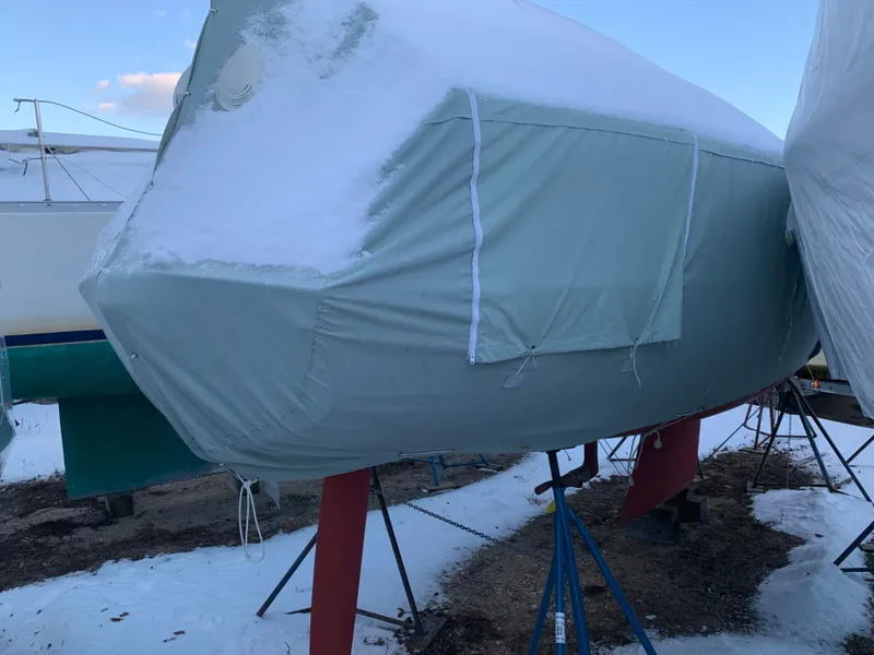 Slide: The Image of Alerion Express 28 sailboat, 2003 model, covered in snow and tarp, on stands. - 17