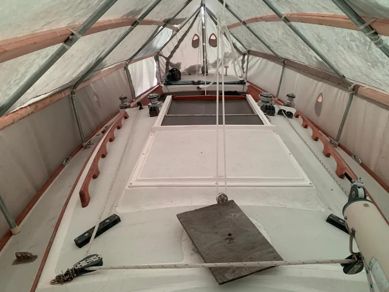 Slide: The Image of Alerion Express 28 sailboat under protective cover, 2003 model, interior view. - 19