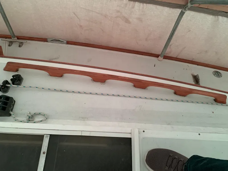 Slide: The Image of 2003 Alerion Express 28 deck with wooden trim and rigging details. - 23