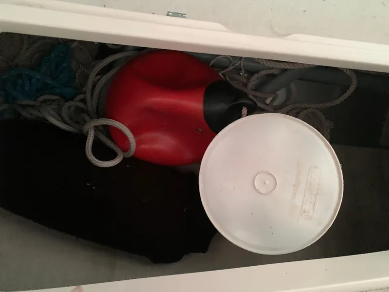 Slide: The Image of Storage compartment of 2003 Alerion Express 28 with ropes and a red buoy. - 26