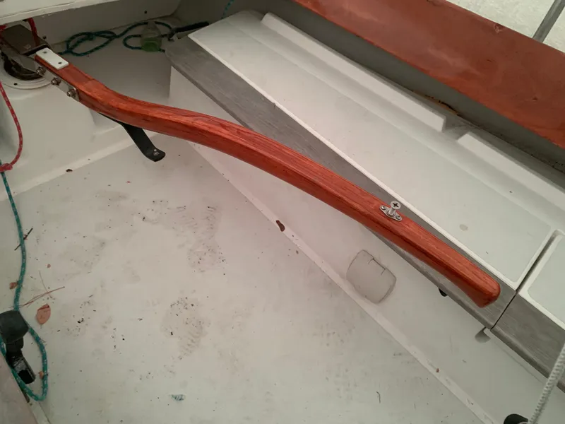 Slide: The Image of Wooden tiller in a 2003 Alerion Express 28 sailboat cockpit. - 28