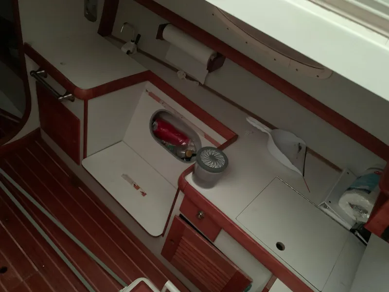 Slide: The Image of Interior of a 2003 Alerion Express 28 sailboat, featuring a compact galley area. - 38