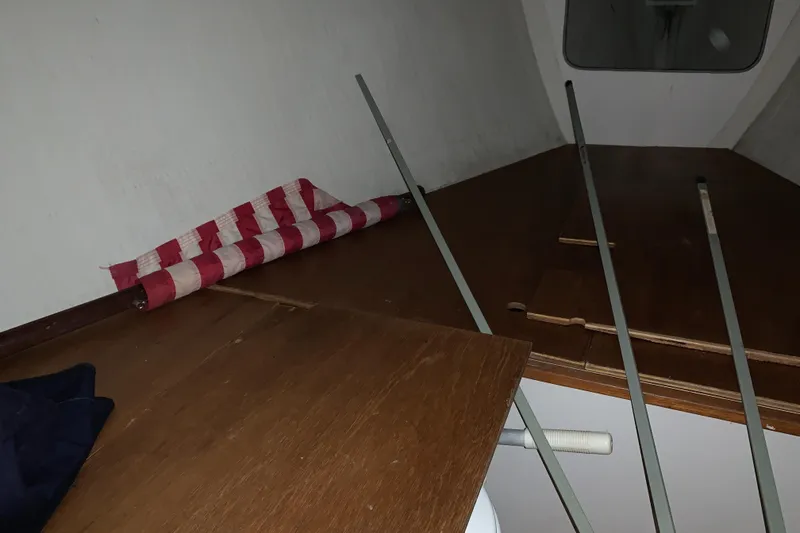 Slide: The Image of Interior of a 2003 Alerion Express 28 sailboat with wooden surfaces and striped fabric. - 45