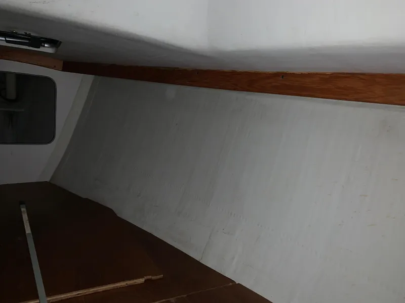 Slide: The Image of Interior view of a 2003 Alerion Express 28 sailboat, featuring wooden trim and white walls. - 47