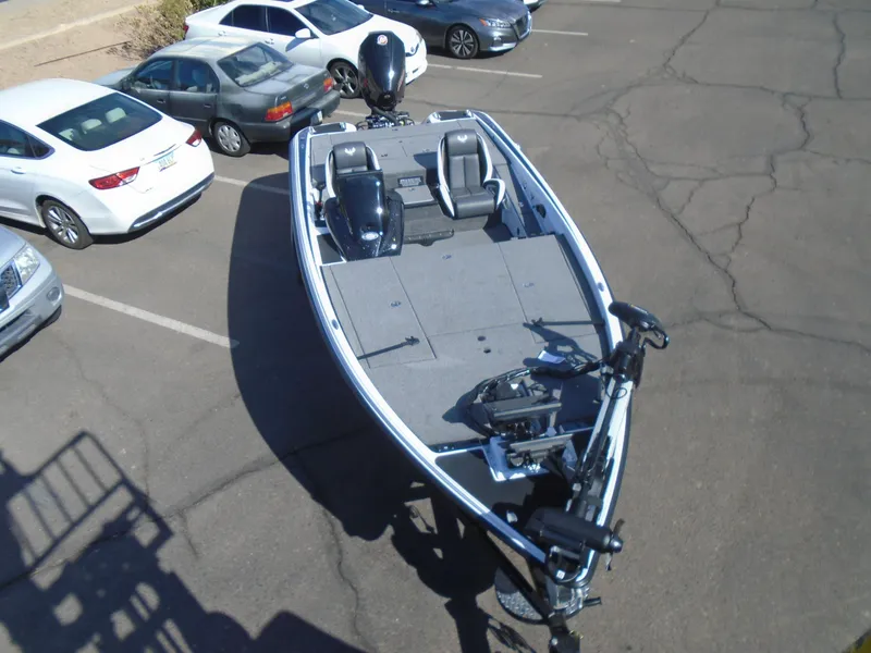 Slide: The Image of 2025 Phoenix 721 ZXL boat in parking lot, surrounded by cars. - 12