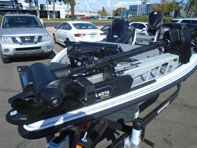 Slide: The Image of 2025 Phoenix 721 ZXL boat with Minn Kota Ultrex trolling motor in parking lot. - 13